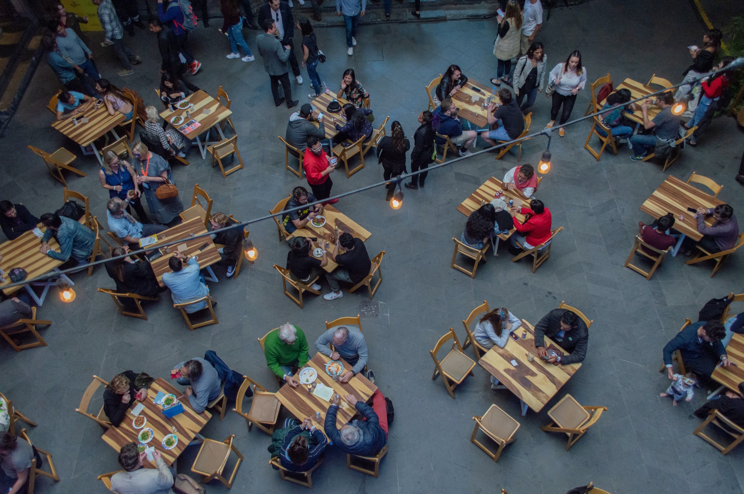 people eating no tables at the food court