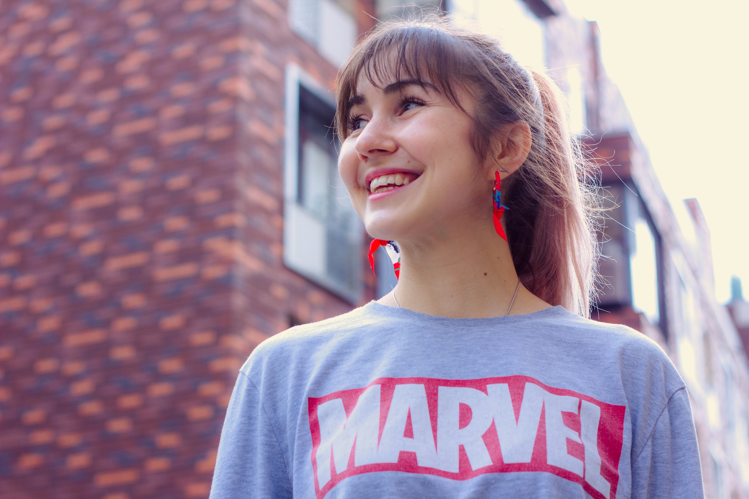 beautiful woman smiling, wearing a marvel shirt